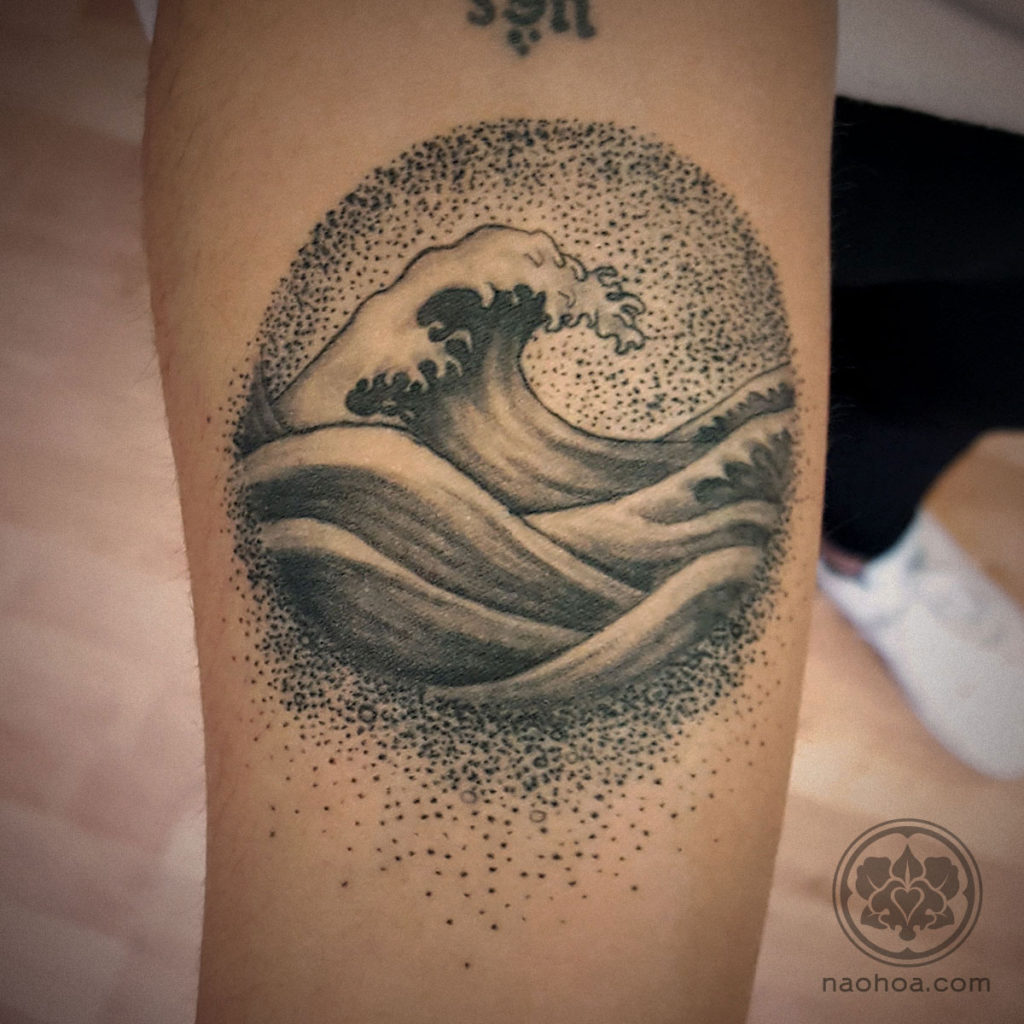 A black and white tattoo of the Japanese Great Wave and dot work