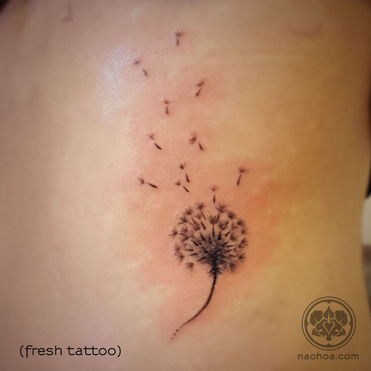 Tattoo of a delicate dandilion, blowing gently in the wind. Designed and tattooed by Naomi Hoang at NAOHOA Luxury Bespoke Tattoos, Cardiff (Wales, UK).