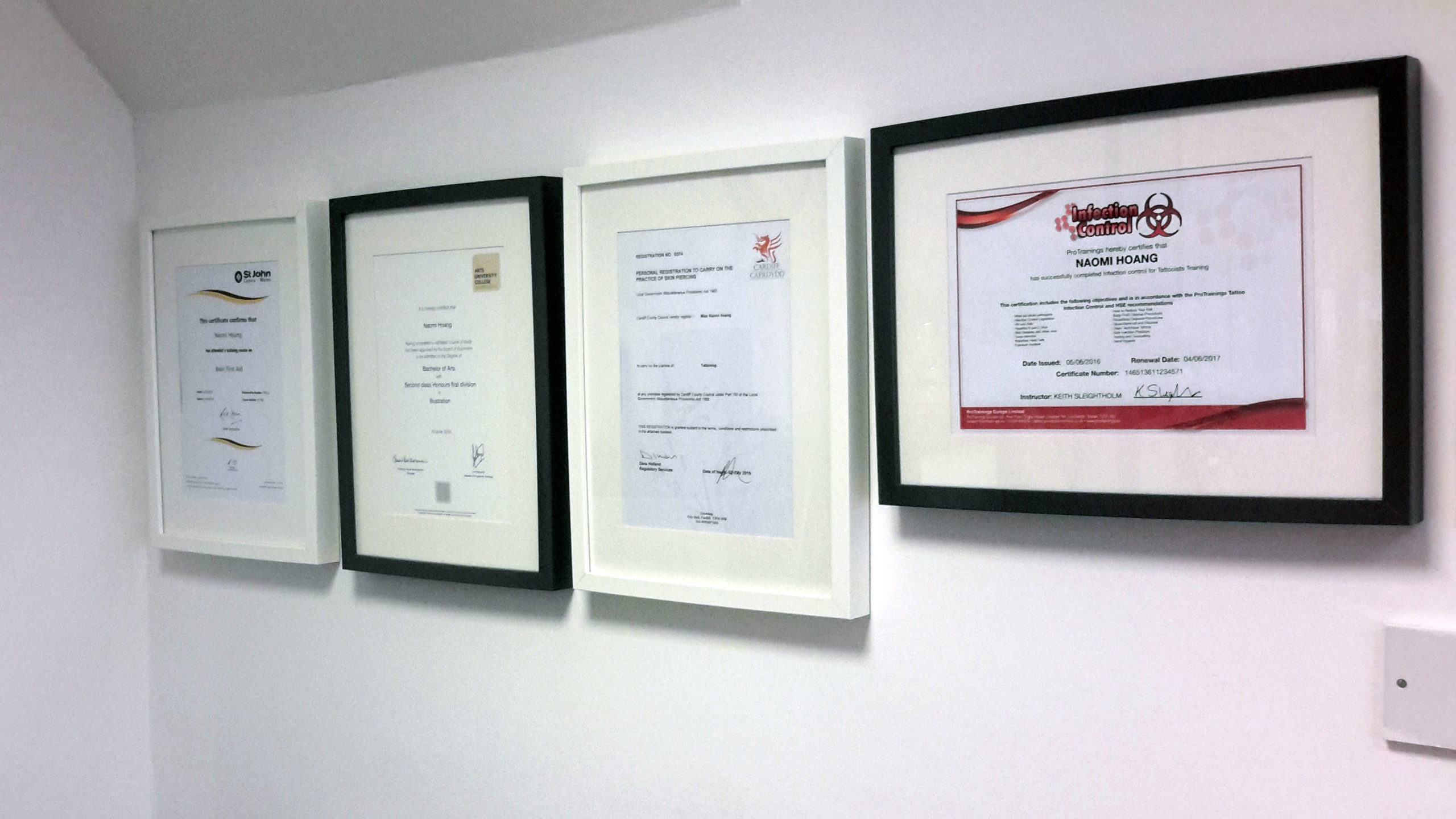 Certificates are clearly on display at NAOHOA Luxury Bespoke Tattoos, Cardiff, Wales (UK).