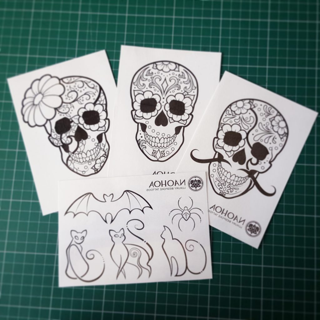 Photo of sugarskull and halloween-themed temporary tattoos designed by Naomi Hoang at NAOHOA Luxury Bespoke Tattoos, Cardiff. Sold to raise money for Mind in support of mental health treatment and awareness.