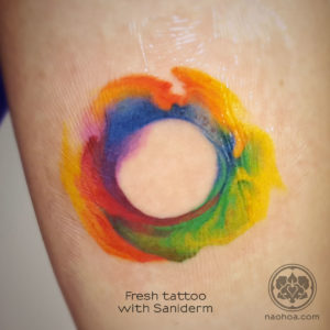 Photo of a vibrant, colourful watercolour-style tattoo. Designed and tattooed by female tattoo artist Naomi Hoang at NAOHOA Luxury Bespoke Tattoos, Cardiff (Wales, UK).