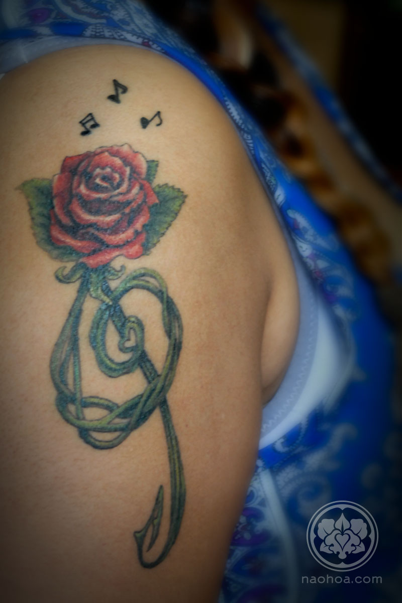 Single needle treble clef rose tattoo on the inner