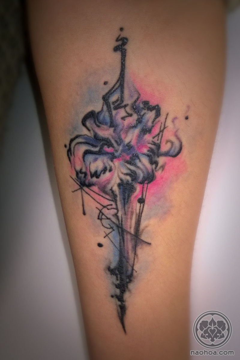 A unique tattoo design of an abstract pink and purple flower with black geometric shapes applied.