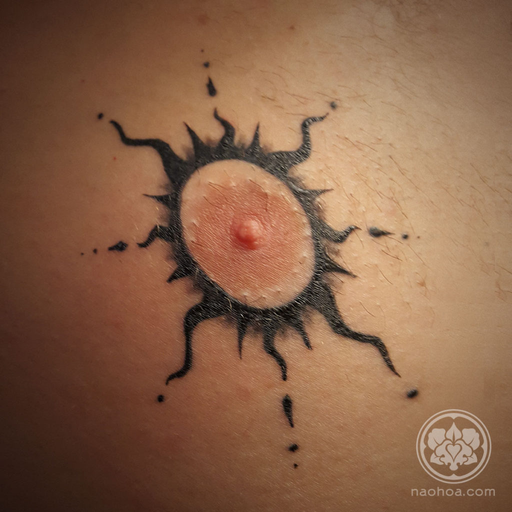 Healed tattoo of a black stylised sun around a nipple. Designed and inked at NAOHOA Luxury Bespoke Tattoos (Cardiff, Wales, UK) by Naomi Hoang.